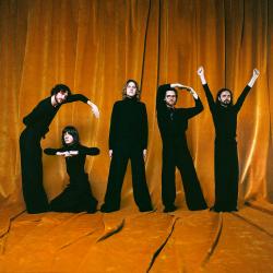 Cover of Gary album by Blossoms featuring the band members dressed in black, spelling out GARY against an orange background